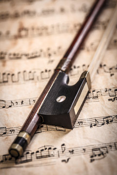 Violin bow on musical sheets