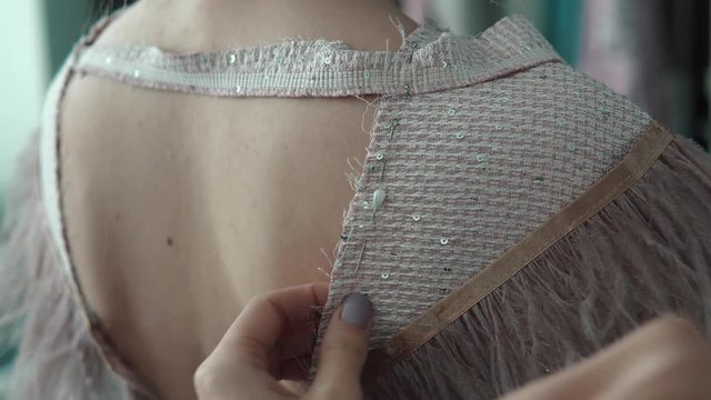 Young fashion designer, tailor and dressmaker customize clothes for the client