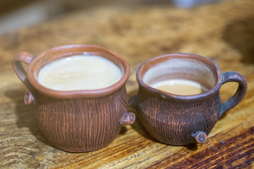 Obraz na płótnie Canvas Clay coffee cup with espresso on wooden table.