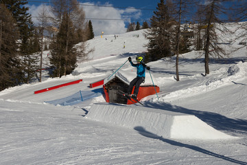 Skier in Action: Ski Jumping in the Mountain Snowpark