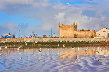 sunset in the background in the beach at Essaouira, Morocco.