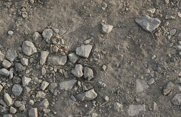dry road with dirt sand and small stones pebbles