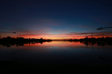Naklejka premium After Sunset on the Ski Rixen Lake with Reddish Orange Clouds at Quiet Waters Park, Deerfield Beach, Florida