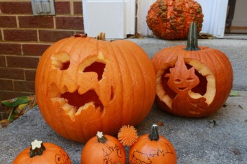 Large and Small Halloween Jack-o-Lantern Pumpkins on Doorstep of Town House in Burke, Virginia with...