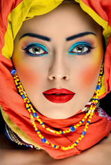 bright african creative makeup on the face of caucasian girl
