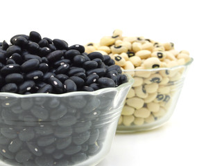glass bowl full of black small beans on white background