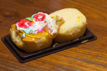 Cake defrmed ugly on wooden table.