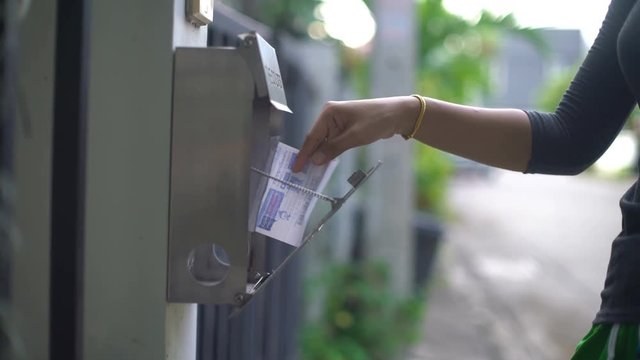 Getting electricity bill out of post box closeup 4k UHD 3840x2160
