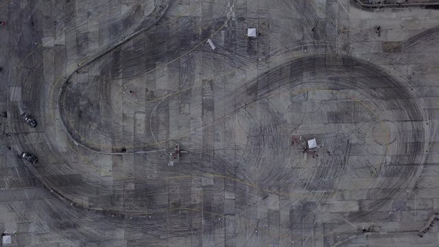 Aerial top view of the car drifting on the race track.