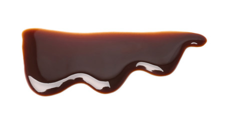 Flowing chocolate sauce on white background