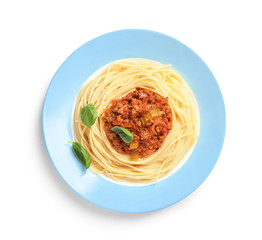 Plate with delicious pasta bolognese on white background, top view