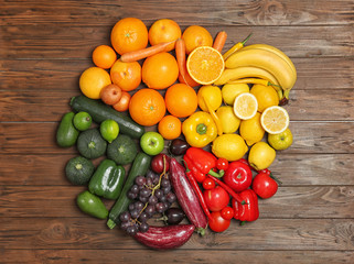 Rainbow composition with fresh vegetables and fruits on wooden background, flat lay
