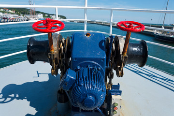 anchor windlass on forecastle of boat in port of sassnitz, ruegen, germany