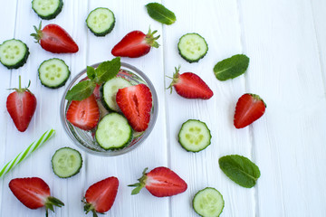 Detox water  with strawberry and cucumber  on the  white wooden background.Top view.