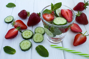 Detox water  with strawberry and cucumber  on the  white wooden background