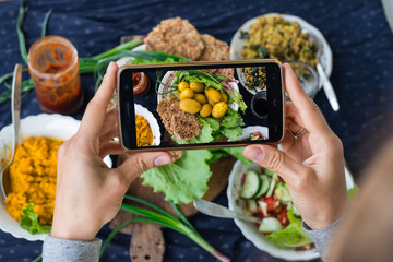 Woman hands take phone photography of food. Smartphone photo of lunch, dinner, food for social...