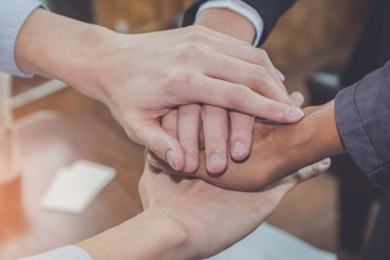 Group of diverse hand together joining concept during a meeting in the office for business cooperation.