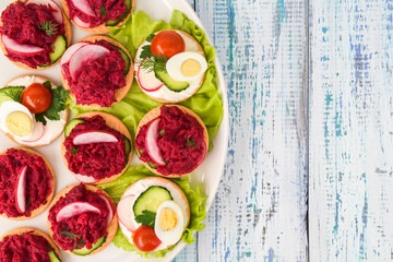 assortment of vegetable appetizers with beets, cucumbers, radishes, eggs and herbs