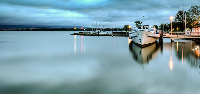 calm harbor early in the morning on Lake Morat in Switzerland