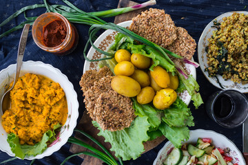 Vegetarian lunch set. Healthy farm food products. Backed new potatoes, buckwheat porridge, carrot hummus, vegetables salad, whole wheat breads. Raw vegan style
