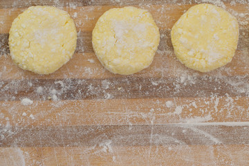 dough for cheese pancakes on a wooden board