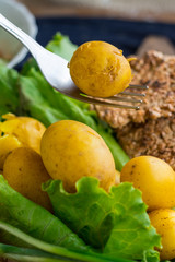 Backed potatoes on lunch. Cooked new potatoes for dinner with olive oil, butter, salad leaves and onion sprouts. Raw vegan vegetarian healthy food
