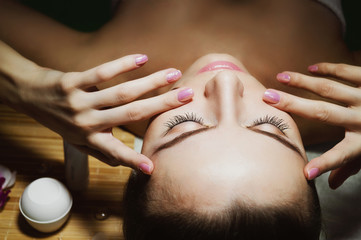 Beautiful natural girl woman in the spa salon, It makes a face massage, facial rejuvenation procedure, spa treatments. Visit a beautician, massage lines. Cosmetology. Massage Toffa. Mesotherapy