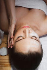 Beautiful natural girl woman in the spa salon, It makes a face massage, facial rejuvenation procedure, spa treatments. Visit a beautician, massage lines. Cosmetology. Massage Toffa. Mesotherapy