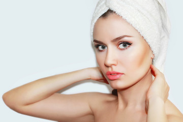 Beautiful natural girl woman after cosmetic procedures ,face-lift , facial massage , visit a beautician , massage lines. Beautiful woman with a towel on his head. Spa treatments