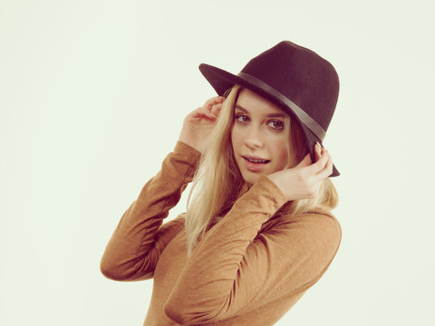Woman wearing suede and black hat