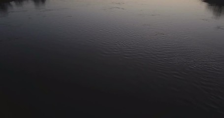 beautiful flight over the bridge and river at sunset. a girl stands on the bridge looking at the river. landscape