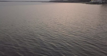 beautiful flight over the lake and the beach at sunset. landscape