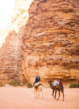 Bedouin with his camels in Wadi Rum desert.