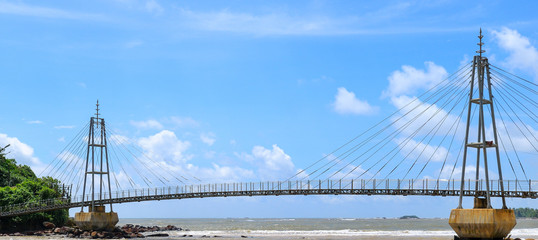 Bridge to the island with a Buddhist temple, Sri Lanka. Wide photo.