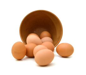 wood bowl with brown eggs over the white background