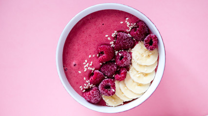 smoothie bowl frozen raspberry and banana, healthy nutrition, pink background