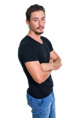Studio shot of young handsome man standing with arms crossed iso