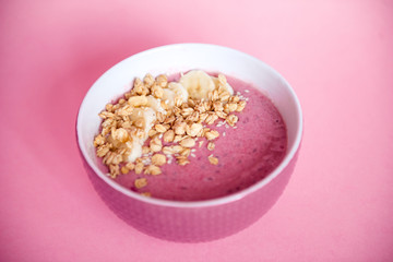 Fototapeta na wymiar pink smoothie bowl cereal and banana