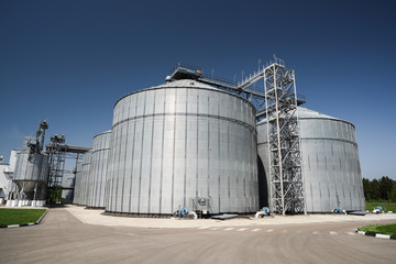 Modern granary. Agro-industry storage technology in animal feed factory. Big metal containers for grain storage