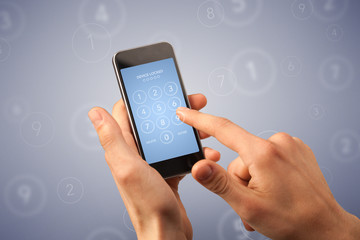 Female fingers touching smartphone with locked device requiring passcode