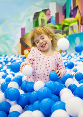 Fototapeta na wymiar Enthusiastic child on a playground in a shopping center