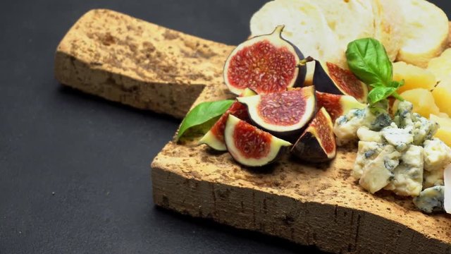 traditional cheese and meat plate wth parma, parmesan and figs