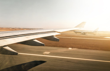 Aerial view out of airplane window while taking off from the runway of the airport