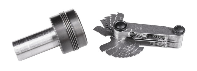 Screw pitch gauge and workpiece. Set of threading gauges for measurement of threads and steel jig....