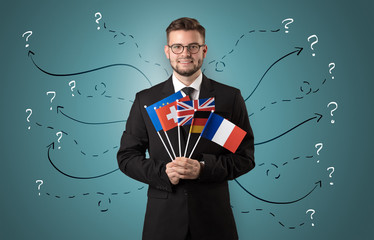 Smiling young man standing with flag and multidirectional arrows around

