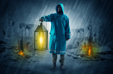 Destroyed place after a catastrophe with man in raincoat and lantern concept
