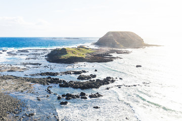 Round island surrounded by water at the Nobbies at Phillip Island, Victoria, Australia