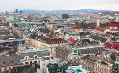 Fototapeta na wymiar Beautiful super-wide angle aerial view of Vienna, Austria, with old town Historic Center and scenery beyond the city, shot from observation deck of Saint Stephens's Cathedral
