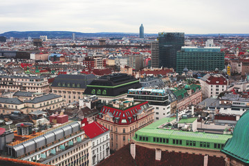 Fototapeta na wymiar Beautiful super-wide angle aerial view of Vienna, Austria, with old town Historic Center and scenery beyond the city, shot from observation deck of Saint Stephens's Cathedral