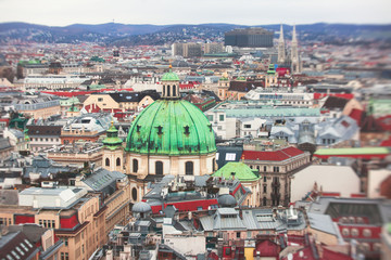 Obraz premium Beautiful super-wide angle aerial view of Vienna, Austria, with old town Historic Center and scenery beyond the city, shot from observation deck of Saint Stephens's Cathedral